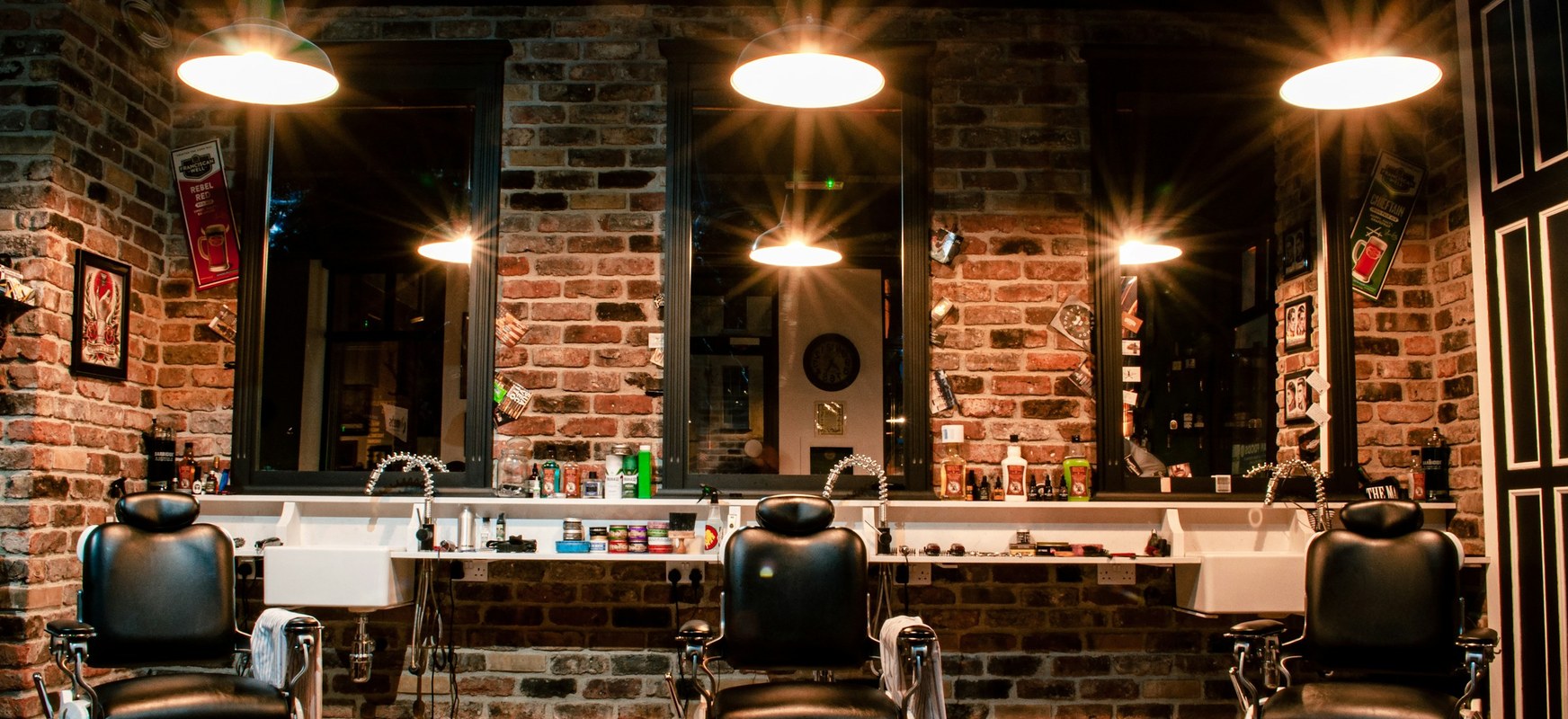 The three chairs and the mirror along the wall of the shop
