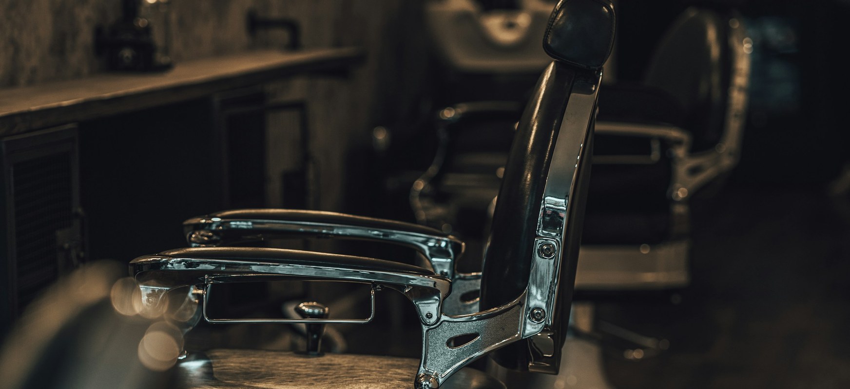 A barber finishing a fade at the first chair